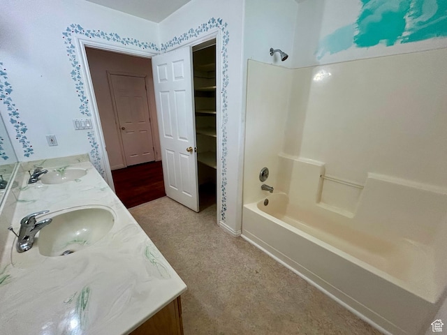 bathroom featuring washtub / shower combination and double vanity