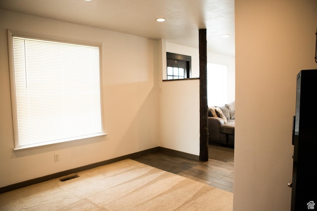 unfurnished room featuring baseboards, dark colored carpet, and recessed lighting