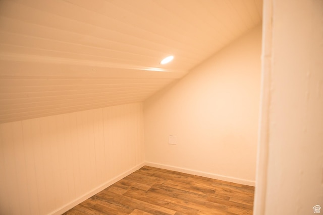 bonus room featuring vaulted ceiling, wood finished floors, baseboards, and recessed lighting