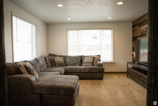 living room with recessed lighting, light colored carpet, and baseboards