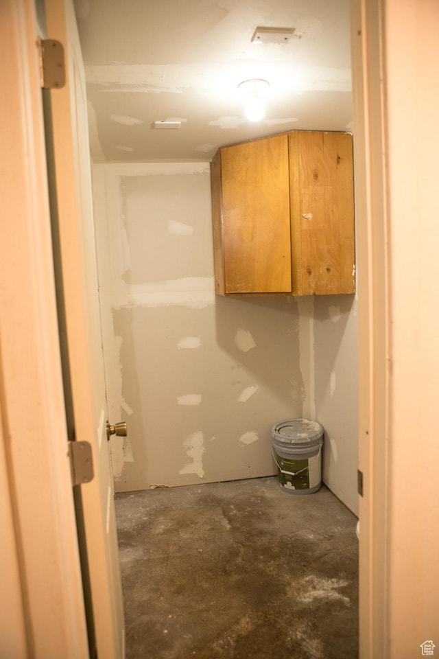 bathroom with unfinished concrete flooring