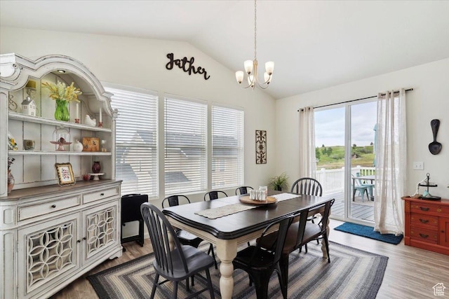 3191 N 1500 E, Layton, UT 84040 - dining space featuring a chandelier, vaulted ceiling, and wood finished floors