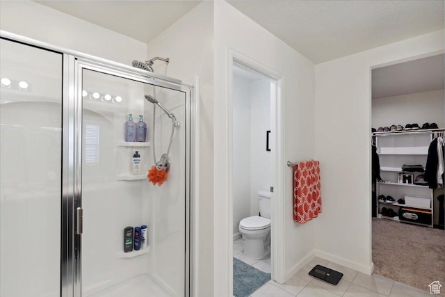 3191 N 1500 E, Layton, UT 84040 - full bath with a stall shower, tile patterned floors, toilet, baseboards, and a spacious closet