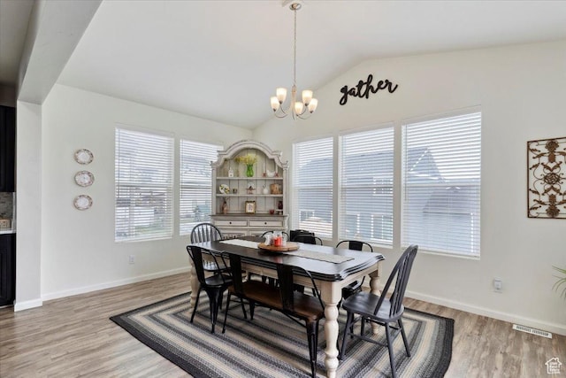 3191 N 1500 E, Layton, UT 84040 - dining space featuring a chandelier, lofted ceiling, light wood finished floors, and baseboards