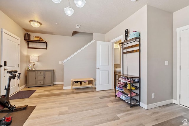 26 N 1100 W, Farmington, UT 84025 - exercise room featuring light wood finished floors, baseboards, and a textured ceiling