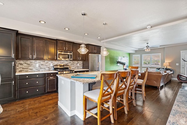 26 N 1100 W, Farmington, UT 84025 - kitchen with stainless steel appliances, dark wood finished floors, dark brown cabinetry, open floor plan, and recessed lighting
