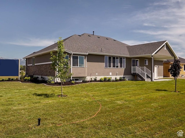 3286 S 2275 W, West Haven, UT 84401 - back of property featuring a yard, stucco siding, and roof with shingles