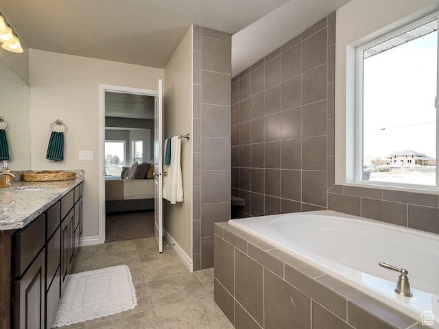 3286 S 2275 W, West Haven, UT 84401 - ensuite bathroom with a garden tub, vanity, baseboards, and tile patterned flooring