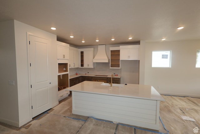 1146 E Hollyhock Way, Layton, UT 84040 - kitchen with custom range hood, black electric stovetop, a kitchen island with sink, backsplash, and white cabinets