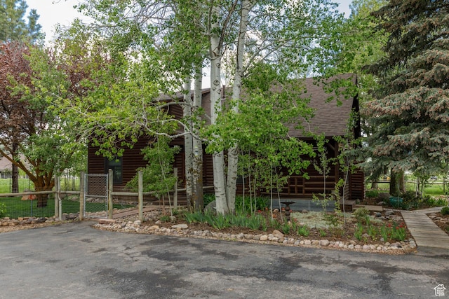 448 S 8600 E, Huntsville, UT 84317 - view of front of home featuring roof with shingles, fence, a gate, and faux log siding
