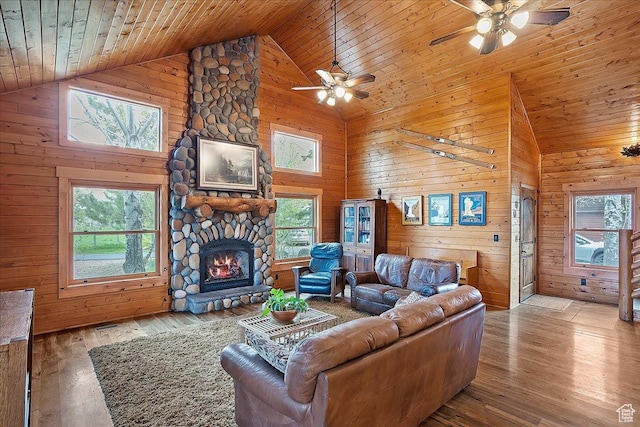 448 S 8600 E, Huntsville, UT 84317 - living room with high vaulted ceiling, a ceiling fan, wooden walls, wooden ceiling, and a stone fireplace