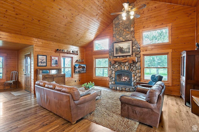 448 S 8600 E, Huntsville, UT 84317 - living room featuring high vaulted ceiling, wooden walls, ceiling fan, light wood-style flooring, and a stone fireplace