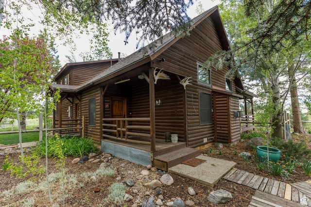 448 S 8600 E, Huntsville, UT 84317 - view of front of home with log veneer siding, covered porch, and a shingled roof