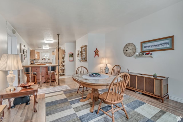 3238 S Maple Way, West Valley City, UT 84119 - dining space with light wood-style floors and baseboards