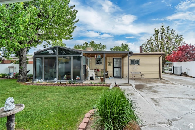 3238 S Maple Way, West Valley City, UT 84119 - back of property featuring a sunroom, driveway, a chimney, and a porch