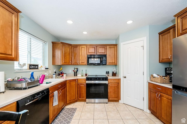 101 E 630 N # 7, Smithfield, UT 84335 - kitchen featuring black appliances, brown cabinetry, light tile patterned floors, light countertops, and recessed lighting