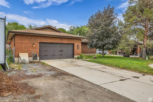 926 N 400 E, American Fork, UT 84003 - view of side of home featuring brick siding, concrete driveway, a garage, and a yard