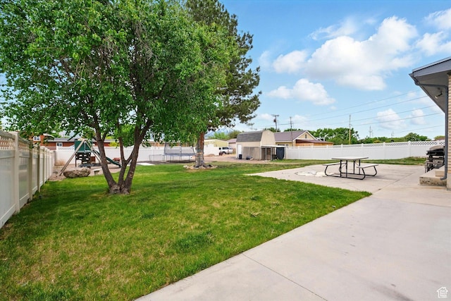 view of yard with a playground and a patio