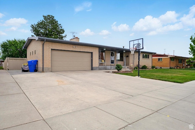 view of front of house with a garage, a chimney, a front lawn, concrete driveway, and brick siding