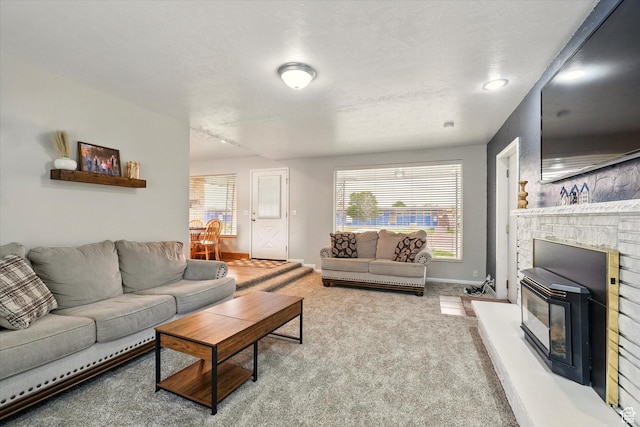 carpeted living area featuring plenty of natural light and baseboards