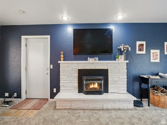carpeted living area with a glass covered fireplace, baseboards, and recessed lighting