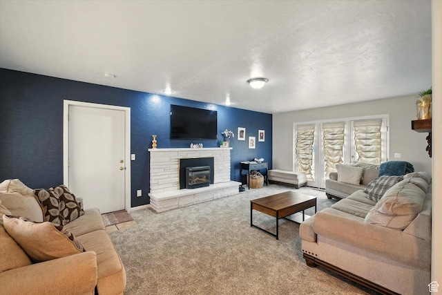 living room with carpet, a fireplace, and baseboards