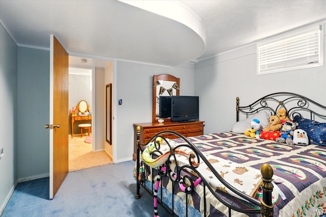 carpeted bedroom with ornamental molding and baseboards
