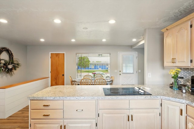 kitchen featuring black electric stovetop, recessed lighting, a peninsula, light wood-style flooring, and light brown cabinets