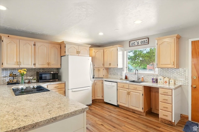kitchen featuring white appliances, light brown cabinets, a sink, tasteful backsplash, and recessed lighting