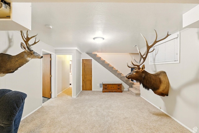 additional living space featuring carpet floors, stairway, and baseboards