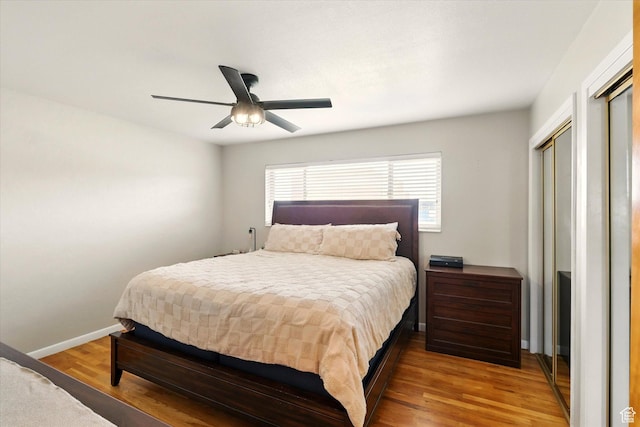 bedroom with wood finished floors, baseboards, and a ceiling fan