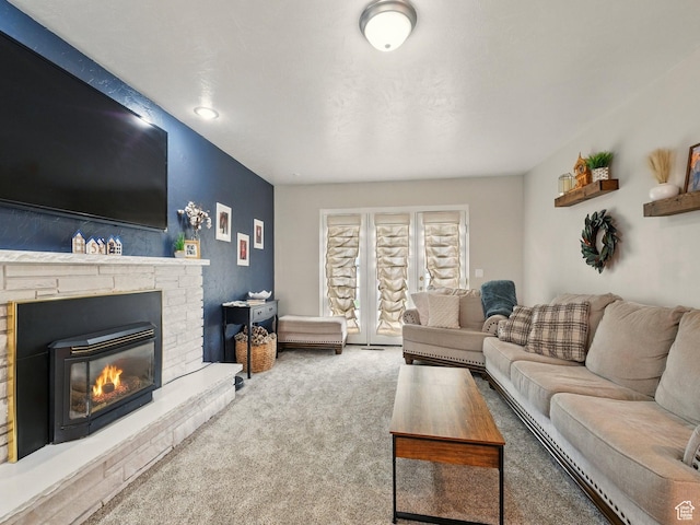 living room featuring carpet floors and a glass covered fireplace