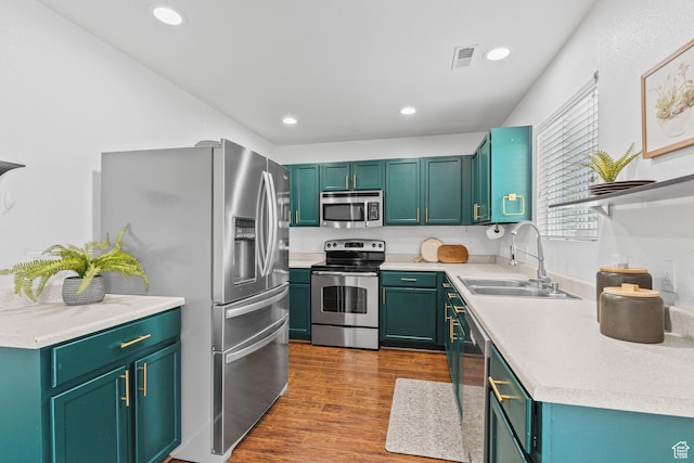 2868 W Willow Sprout Rd S, Lehi, UT 84043 - kitchen featuring appliances with stainless steel finishes, a sink, light countertops, wood finished floors, and recessed lighting