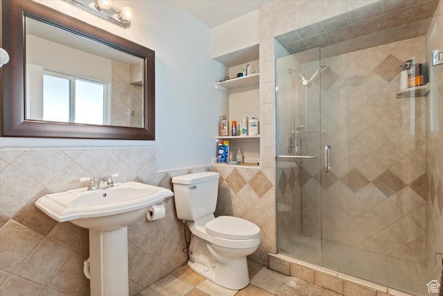 2115 N 600 W, West Bountiful, UT 84087 - bathroom with tile walls, a stall shower, toilet, wainscoting, and tile patterned flooring