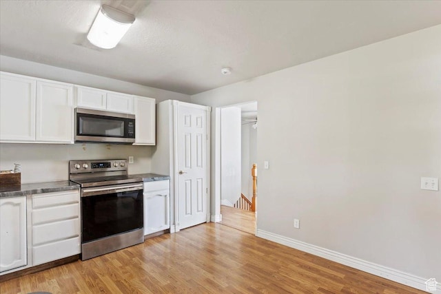 2115 N 600 W, West Bountiful, UT 84087 - kitchen featuring stainless steel appliances, light wood-style flooring, white cabinetry, and baseboards
