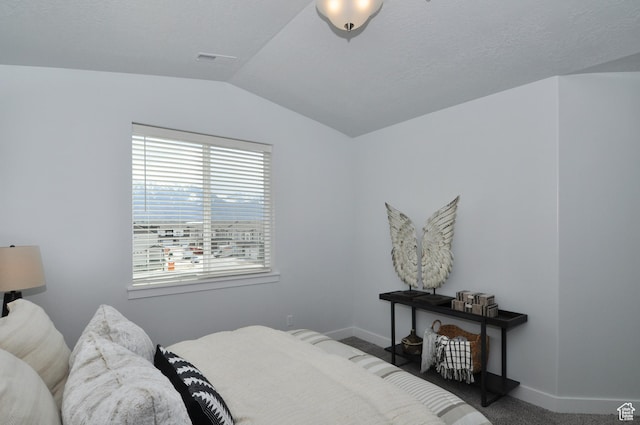 carpeted bedroom featuring lofted ceiling and baseboards