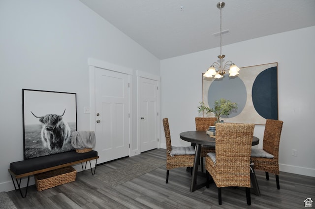 dining area with a chandelier, wood finished floors, vaulted ceiling, and baseboards