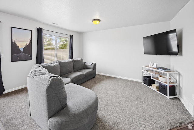 carpeted living area with baseboards