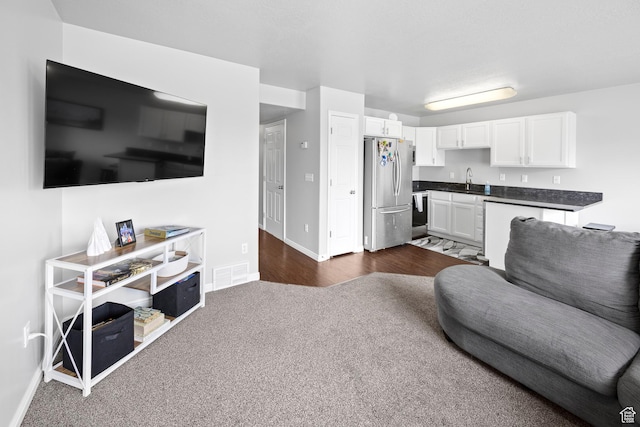 living room with baseboards and dark carpet
