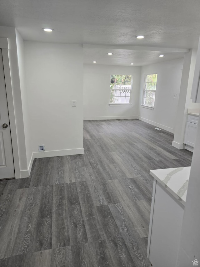 unfurnished room with wood finished floors, baseboards, and recessed lighting