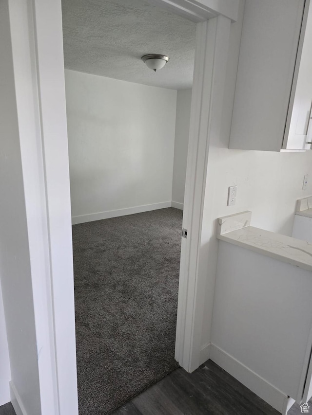bathroom with baseboards and a textured ceiling
