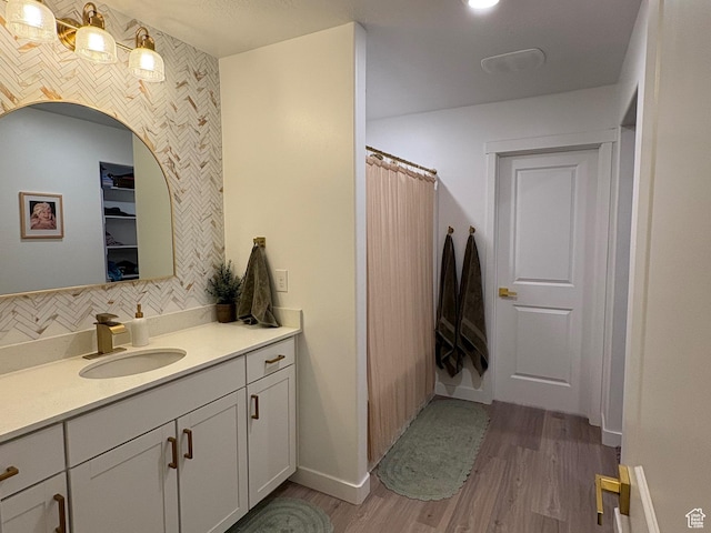 3452 W Pond Dr S, Lehi, UT 84043 - full bath featuring wood finished floors, vanity, decorative backsplash, baseboards, and a shower with curtain