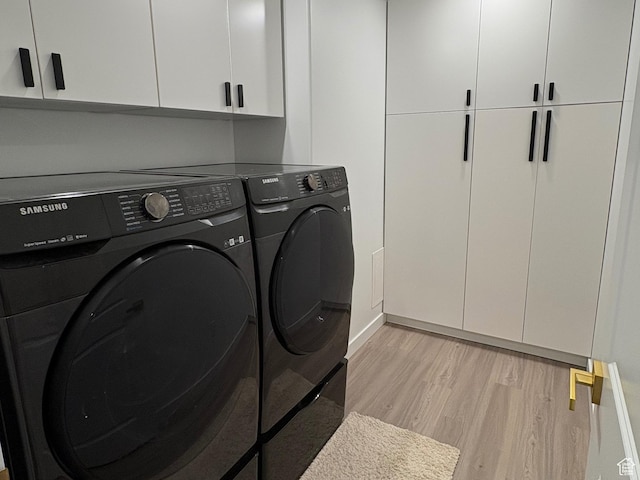 3452 W Pond Dr S, Lehi, UT 84043 - laundry area with washing machine and dryer, cabinet space, light wood-style floors, and baseboards