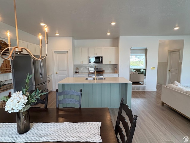 3452 W Pond Dr S, Lehi, UT 84043 - kitchen featuring stainless steel appliances, light wood-style flooring, white cabinets, light countertops, and recessed lighting