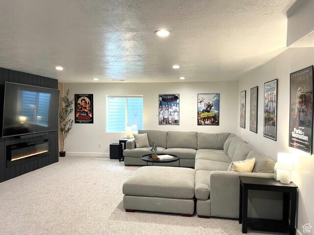 3452 W Pond Dr S, Lehi, UT 84043 - carpeted living area with recessed lighting, baseboards, a glass covered fireplace, and a textured ceiling