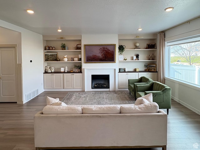 3452 W Pond Dr S, Lehi, UT 84043 - living room with dark wood-type flooring, baseboards, a fireplace, and recessed lighting