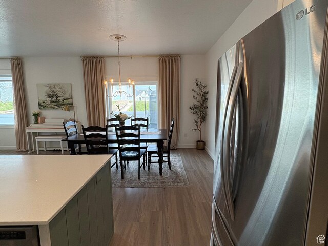 3452 W Pond Dr S, Lehi, UT 84043 - dining space with dark wood-style flooring, a chandelier, plenty of natural light, and baseboards