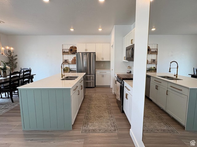3452 W Pond Dr S, Lehi, UT 84043 - kitchen featuring a sink, stainless steel appliances, an island with sink, wood finished floors, and recessed lighting