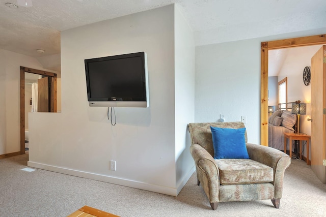 living area featuring carpet and baseboards