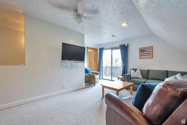 living room with a textured ceiling, baseboards, a ceiling fan, vaulted ceiling, and carpet flooring